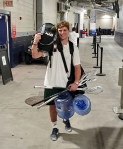 TD Ierlan carrying his equipment, the ball bag, water jugs and lacrosse sticks at a Redwoods practice at Gillette Stadium. (Photo by Nat St. Laurent)