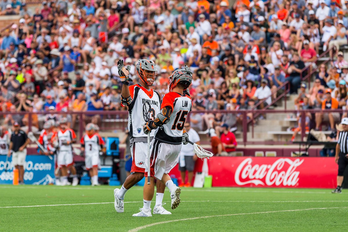 Romar Dennis and Eric Law celebrate a goal together as teammates with the Denver Outlaws