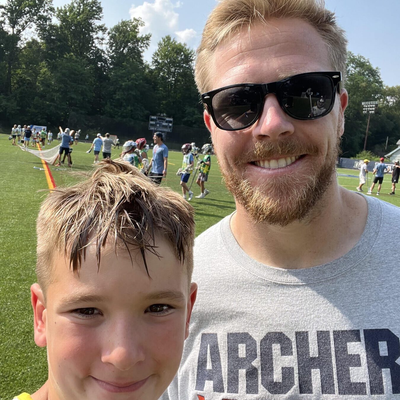 James Henderson with PLL All-Star Tom Schreiber at a lacrosse camp this summer.